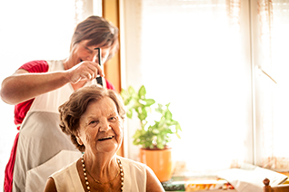 beautician with elderly woman