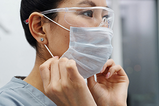 nurse wearing facemask and eye protection